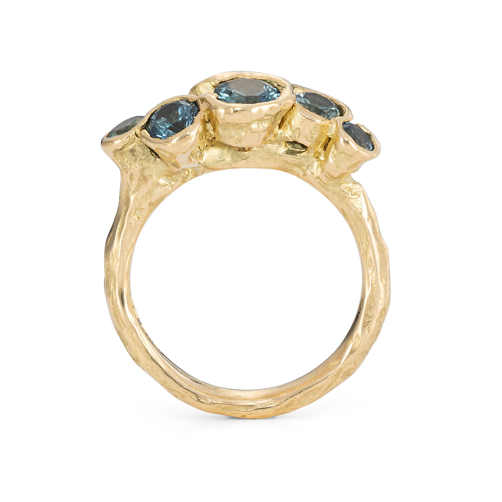 Unique gemstone ring with craggy beach texture, handmade using teal peacock sapphires and a brilliant white diamond.