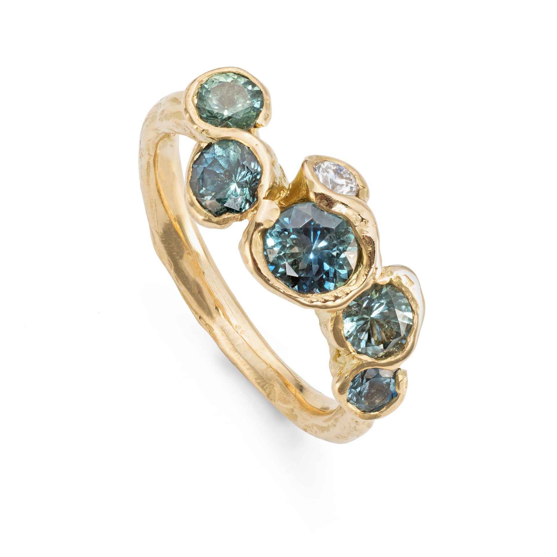 Upright shot of handcrafted gemstone ring featuring five teal sapphires and a brilliant white diamond set in recycled yellow gold.